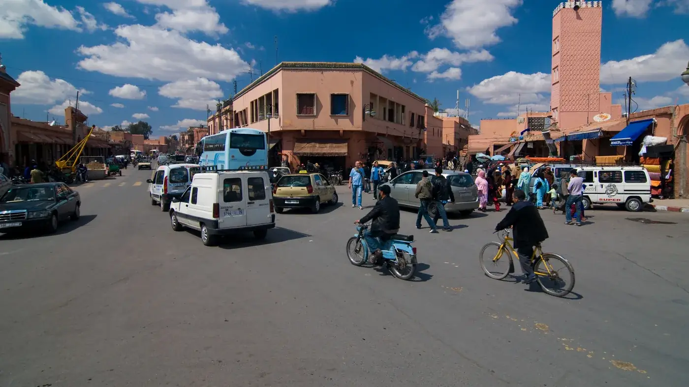 Cars, scooters and bicycles sharing the road, typical of driving in Morocco's big cities